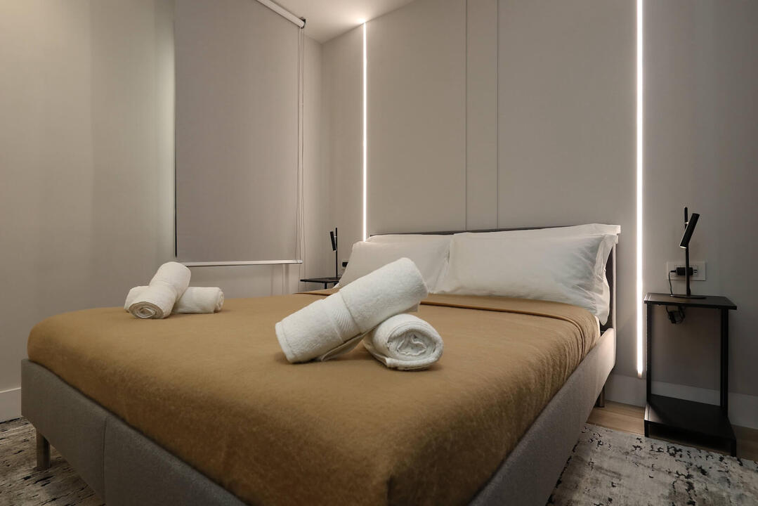 Rest in the spacious master bedroom with a plush king-size bed and premium linens.