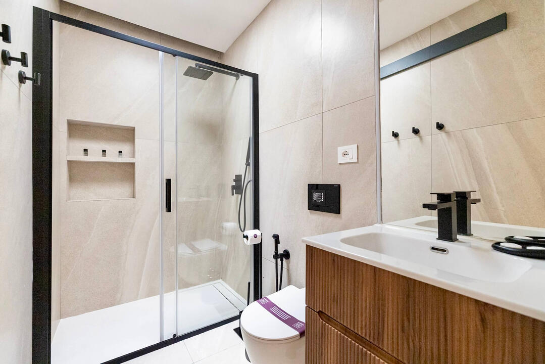 Modern bathroom featuring a sleek walk-in shower and elegant finishes for your comfort. Modern bathroom featuring a sleek walk-in shower and elegant finishes for your comfort.