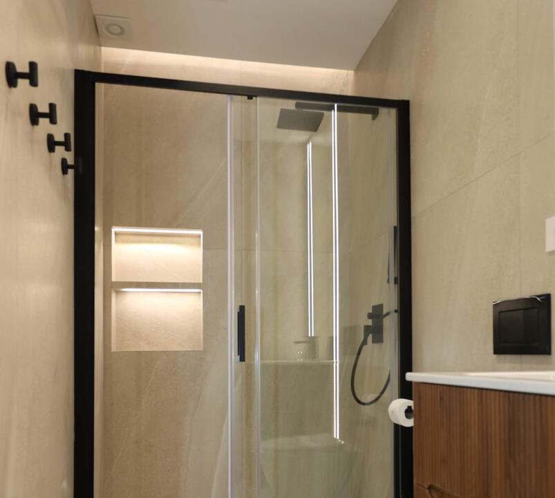 Modern bathroom featuring a sleek walk-in shower and elegant finishes for your comfort.