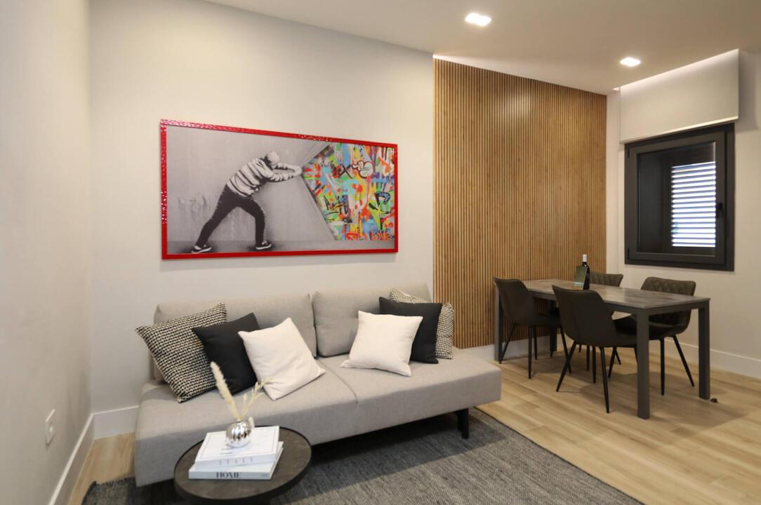Bright and welcoming living area with comfortable seating, large TV, and cozy atmosphere.